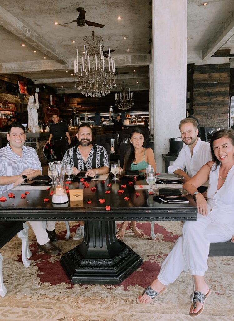 Group enjoying a refined dining experience in Tulum, perfect for luxury travel.
