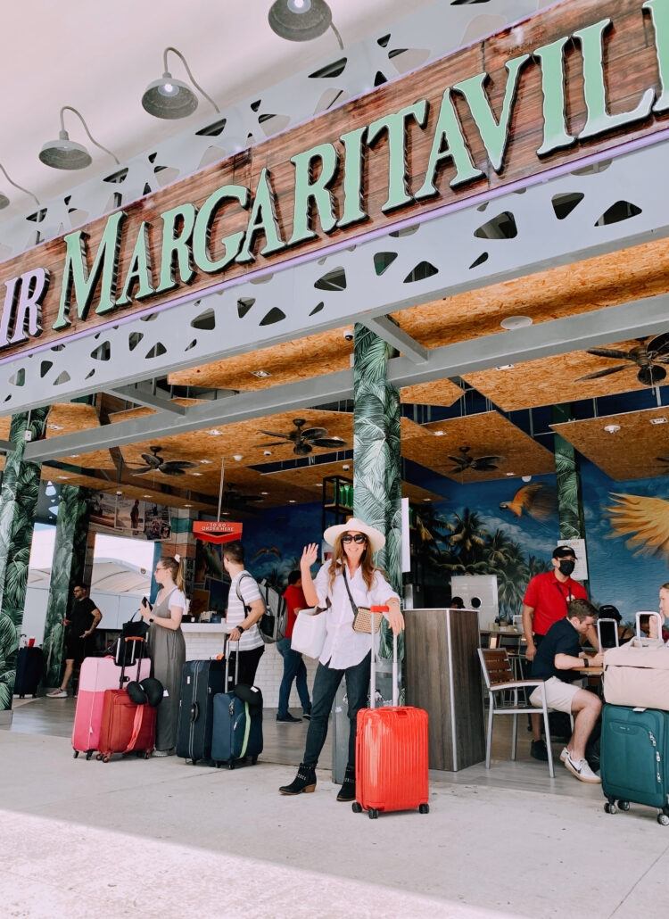 Woman with luggage at Cancun Airport arrival, ready for Tulum luxury travel.