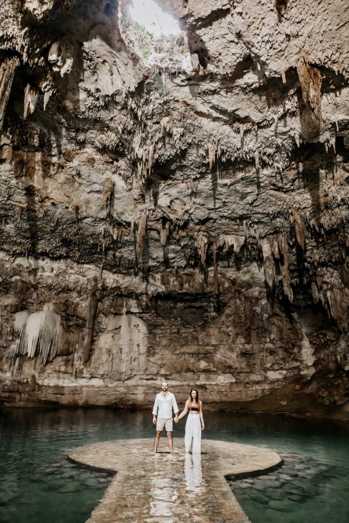 Couple in a stunning cenote, part of a luxury cenotes hopping adventure in Tulum.