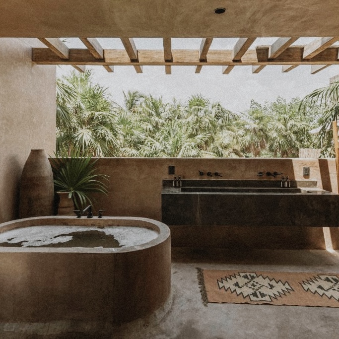 Luxury Tulum accommodations: outdoor bathtub and double vanity with jungle view